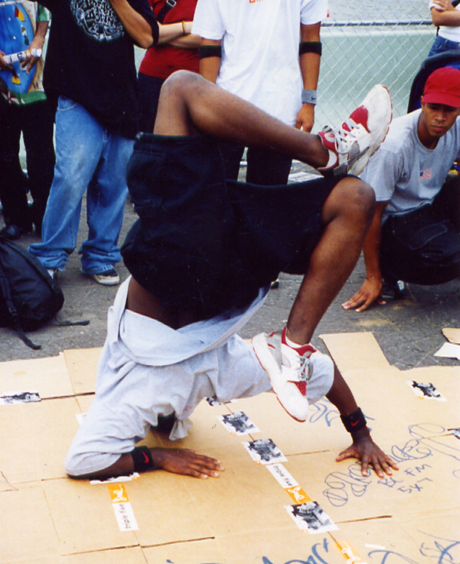 B-boy headspin at a street battle on cardboard