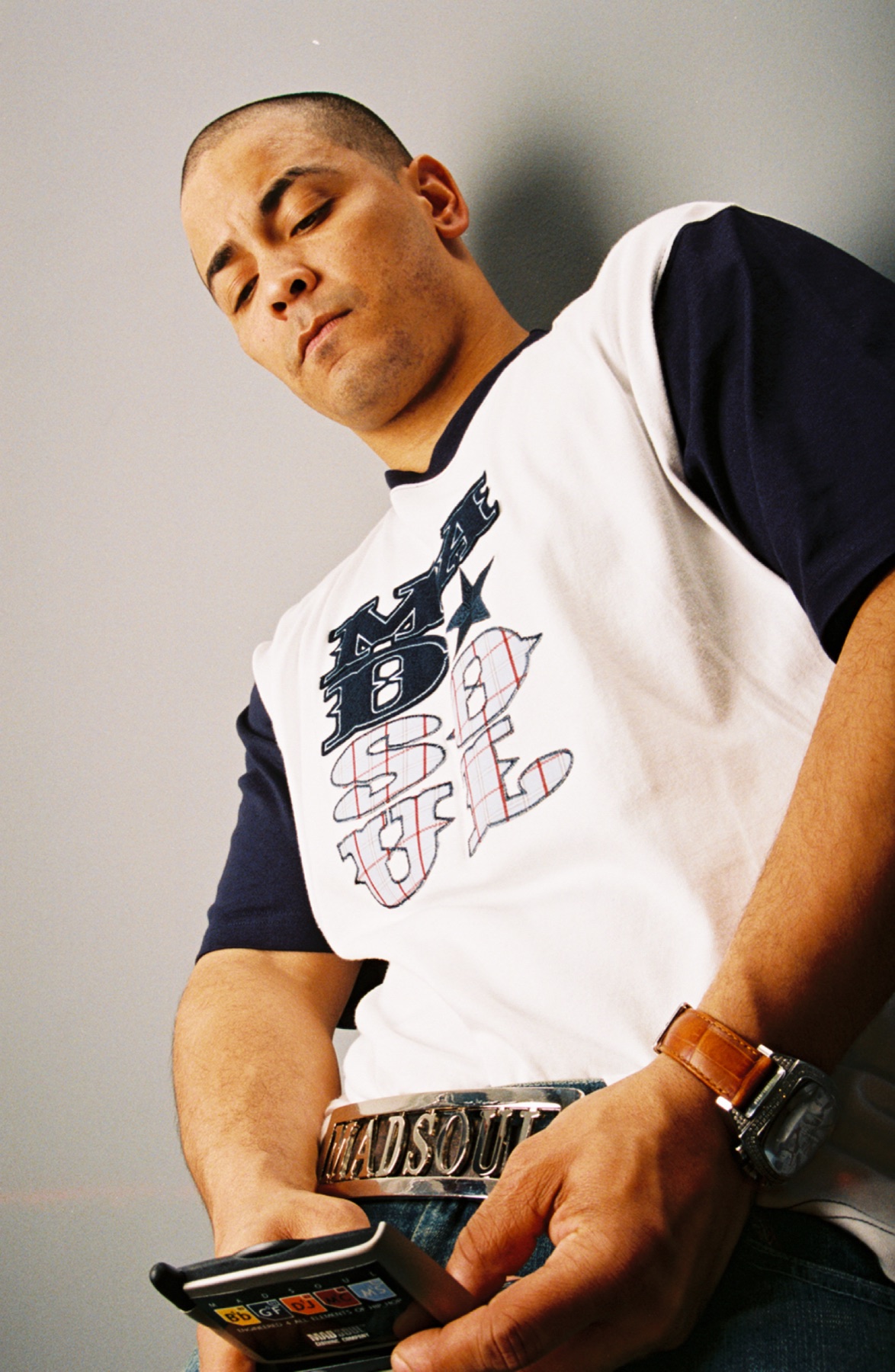 Model holding a Madsoul retail hangtag with the elements badge