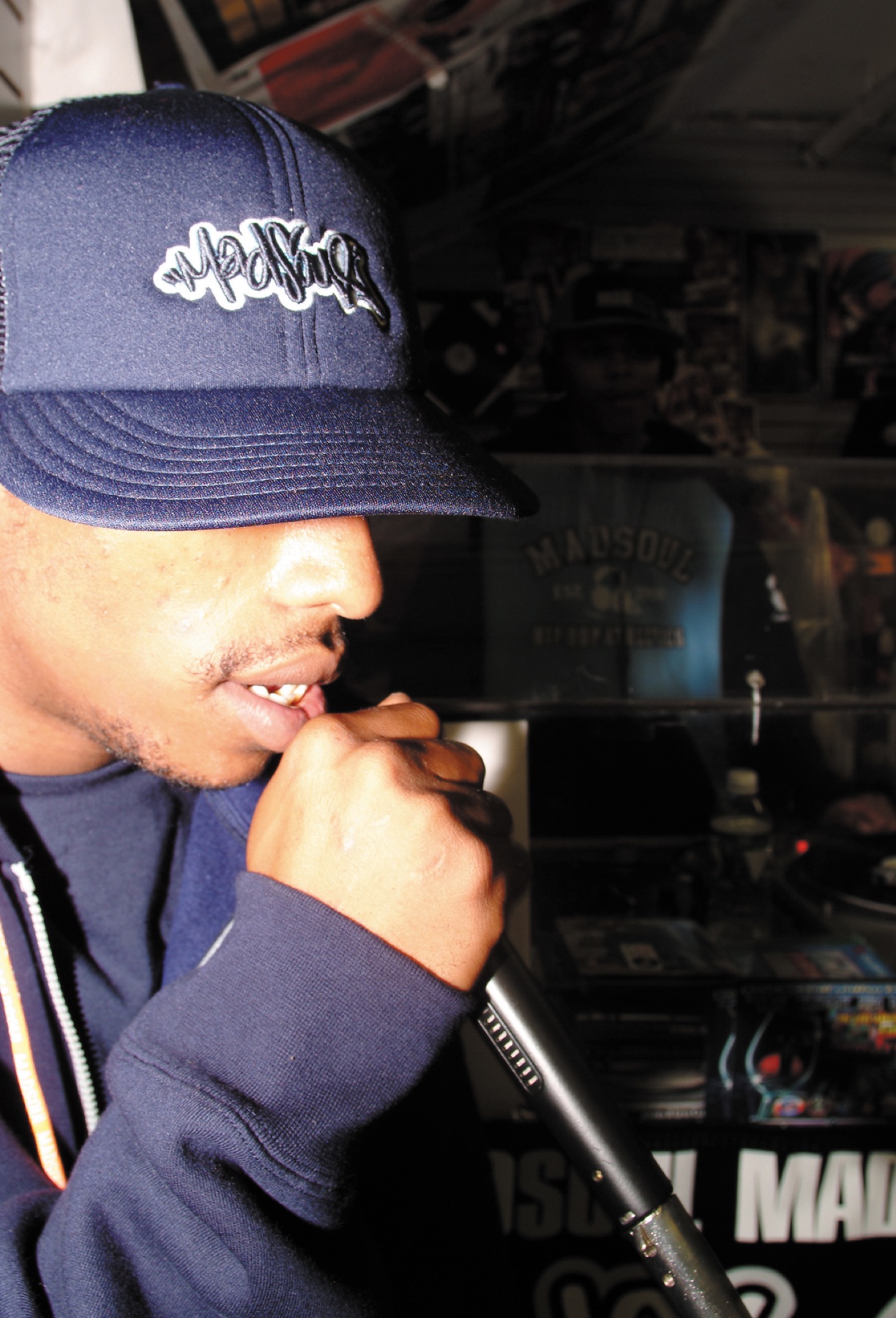 MC performing on a microphone at MAGIC 2003, wearing a Madsoul cap