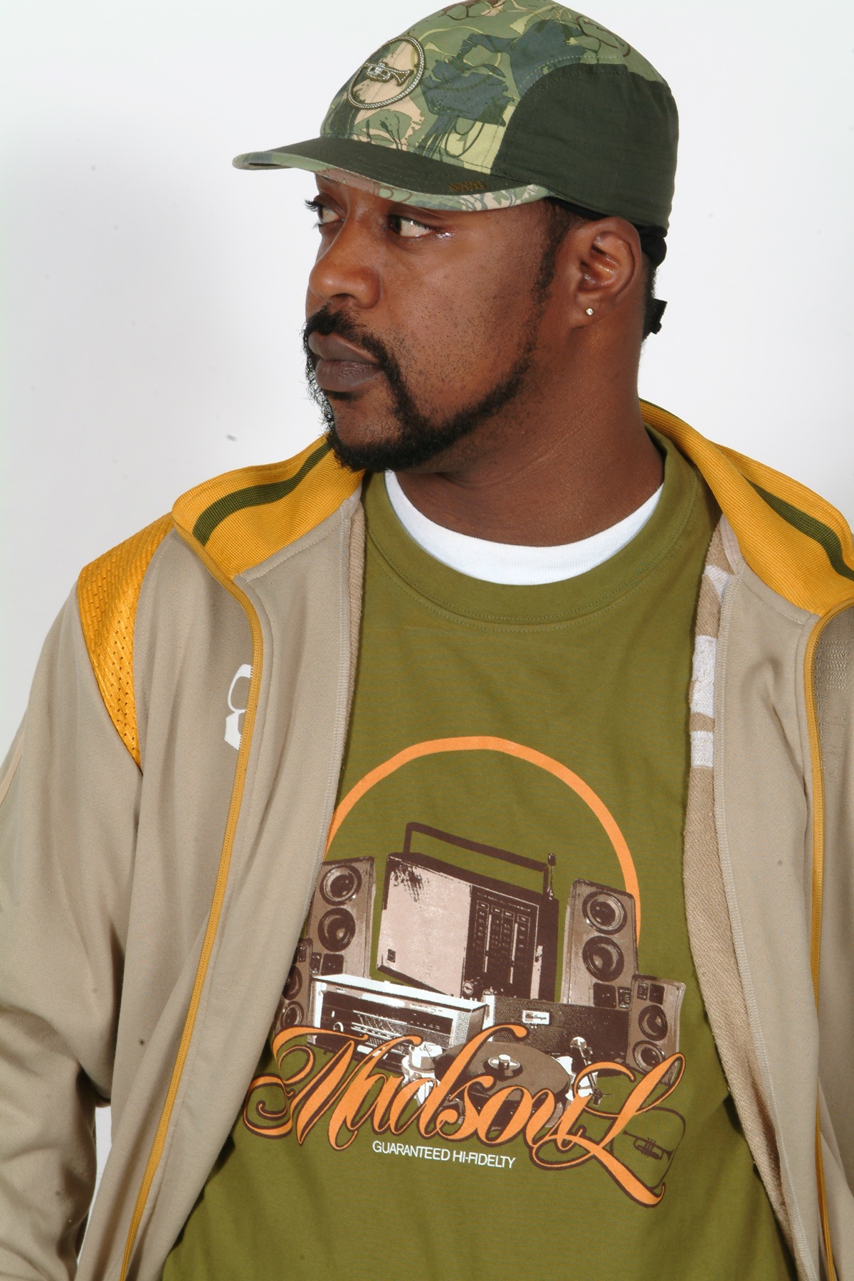Model in the olive Audiophile track jacket with MADSOUL wordmark tee underneath