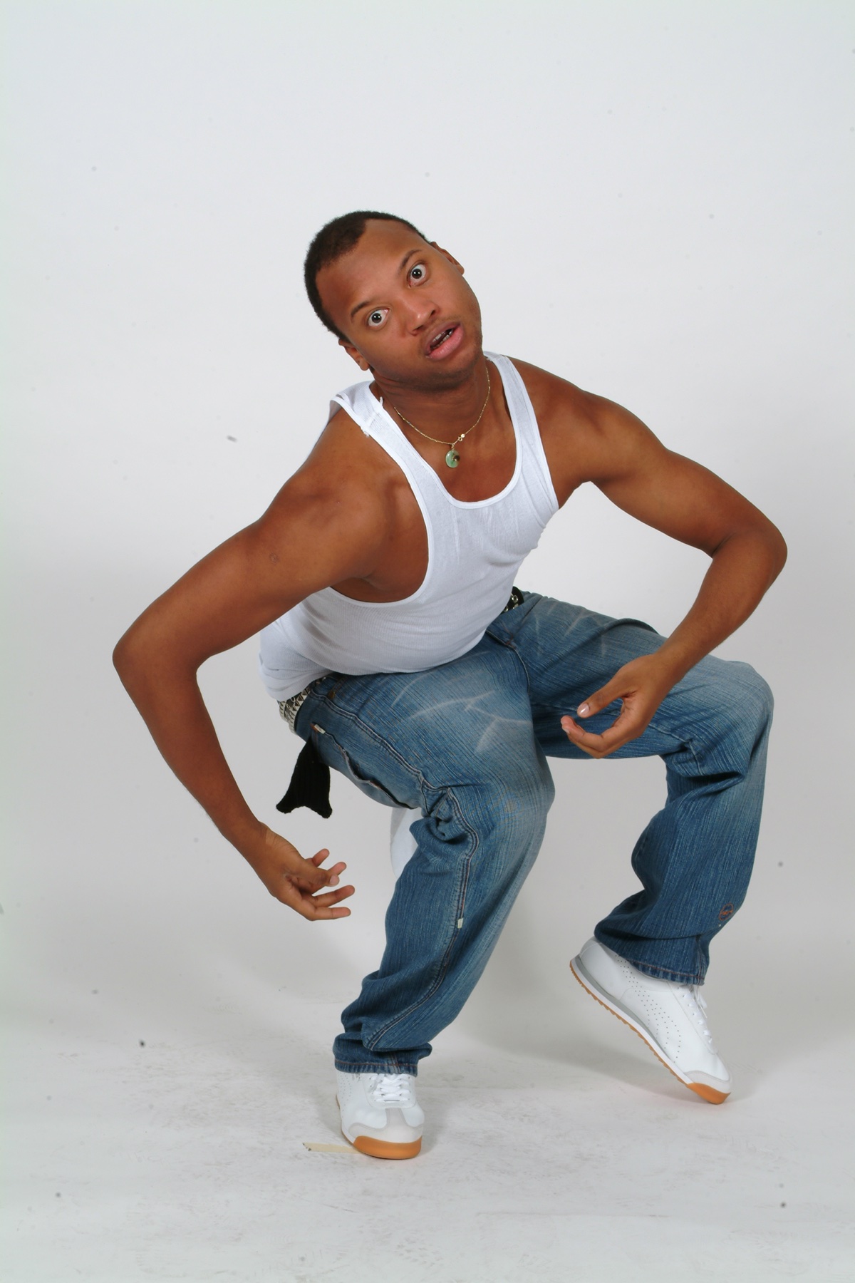 Model in a Madsoul tank top in a dynamic b-boy style crouch