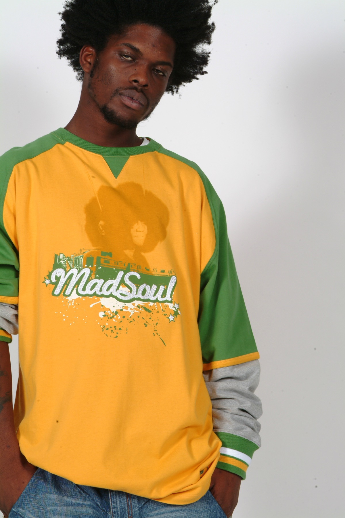 Model in a yellow and green Madsoul jersey with bold chest graphic